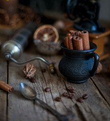 Still life of cinnamon sticks, coffee grains on a wooden table. Copy space.