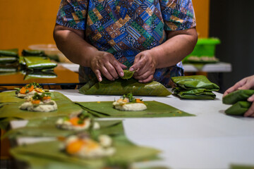 Wrapping tamales Latin American dish.