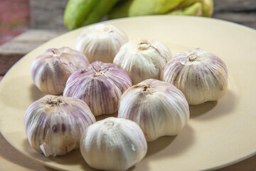 Garlic bulbs in kitchen dish used for seasoning
