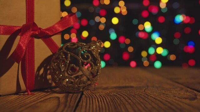 Christmas gift boxe with red ribbon onthe wooden table with bokeh lights.