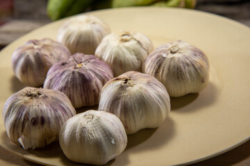 Fresh leek bulbs served on a porcelain plate