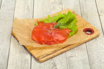 Sliced salmon fillet served rosemary