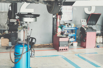 motor oil container for filling old engine oil from car in garage