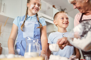 Cute grandchildren being thankful for family cooking experience