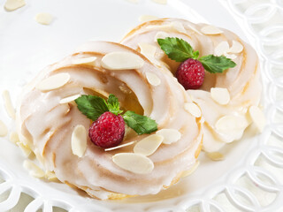 custard cakes with raspberries, cream and almonds