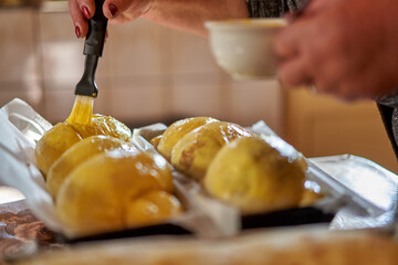 Brushing the cakes with egg yolk