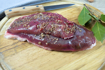 magret de canard cru au sel de guérande sur une planche à découper