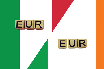 Italy and Ireland currencies codes on national flags background