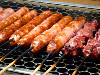Cooked sausage in sticks barbecue