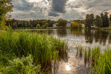 The Kuzminki Estate. Manor pond in the warm early autumn under a stormy sky. Autumn rural landscape. Moscow-September 2020