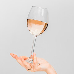 Girl holding a glass with white wine in her hand