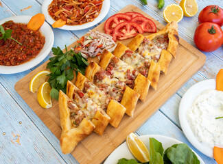 Traditional turkish baked dish pide. Turkish pizza pide, Middle eastern appetizers. Turkish cuisine. Top view. Pide with meat filling.