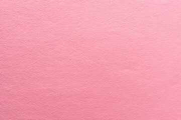 Paper textured background of pastel pink color.