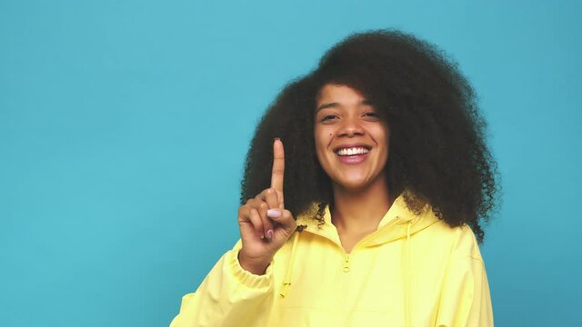 Young african american curly woman showing number one with finger