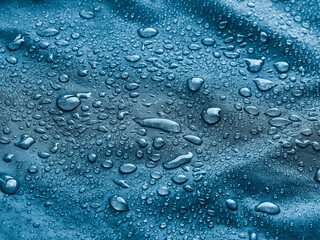 Rain water droplets on waterproof fabric.