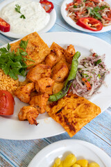 chicken shish kebab in a plate with appetizers