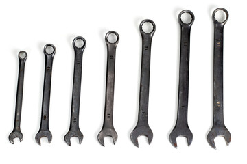 Spanner Set Isolated. dark coloured spanners lying side by side in white background.