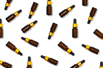 Texture of dark cosmetic glass bottles with serum, essential oil. Patter from beauties aromatic remedy. Natural liquid homeopathic medical face care product, top view.