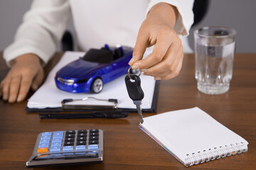 Car insurance and car services concept. Agent, toy car.