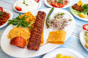 in the plate with the hot kebab and appetizers. adana kebab