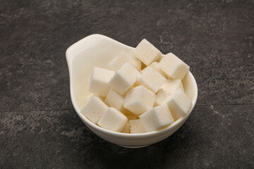 Refined white sugar cubs in the bowl