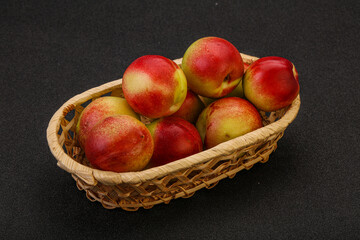 Sweet small nectarines in the basket