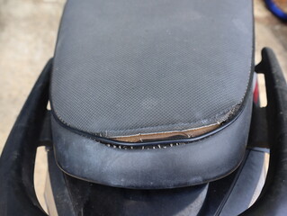 old black leather motorcycle seat is damaged