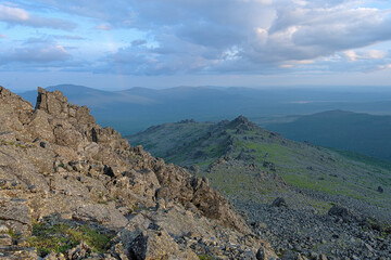 Evening view from the peak of Serebryansky Rock Mount with pale rainbow, Northern Ural Mountains, Russia