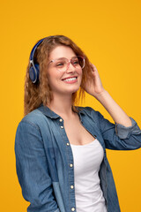 Cheerful woman listening to music with headphones