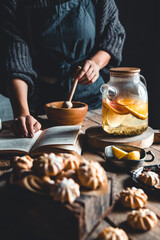 Woman cooks in a vintage kitchen on wooden tablet. Healthy drink, Eco, vegan.