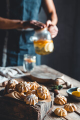 Man pours Hot tea with slices of fresh grapefruit on wooden tablet. Healthy drink, Eco, vegan.