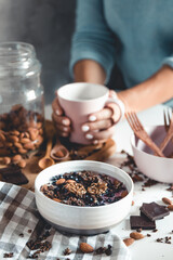 Top view of breakfast table with coffee, granola, nuts, berries and milk. healthy eating concept.