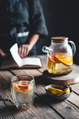 Woman cooks in a vintage kitchen on wooden tablet. Healthy drink, Eco, vegan.