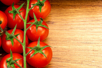 Closeup of some cherry tomatoes on a brown wooden table