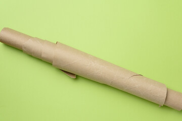 roll of brown parchment paper on a green background