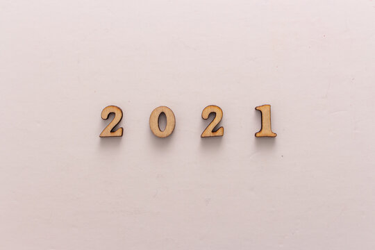Wooden number 2021 on roughy white background. Concept image of celebration new year