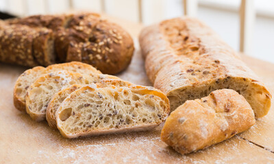 Fototapeta premium fresh loaf of bread on wooden board