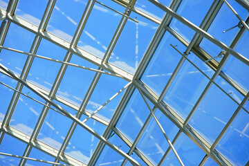 Glass roof of a modern building. Close-up view of the transparent roof. Window sections.