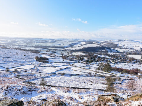 Snow covered Derbyshire landscape under a blue sky