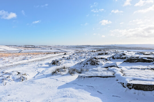 Footprints across a snow covered Derbyshire countryside.