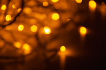 Obraz premium Abstract golden bokeh lights glowing on dark background