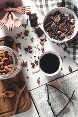 Healthy breakfast. granola, healthy food and education. Open book with glasses, morning coffee and food