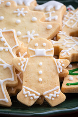 Close up of Christmas sugar cookies in a plate on red table background.