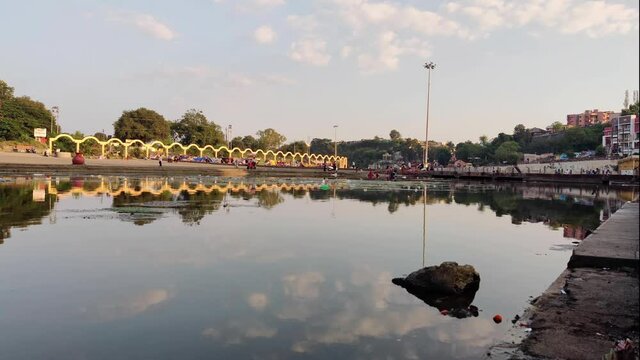 Timelapse Of People Walking Around The Bank Of Godavari River In The Middle Of The City At Day Time - 4K