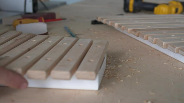 Eco toys and musical instruments made of wood. A master carpenter makes a handmade xylophone for children.
