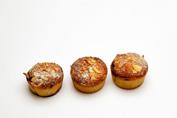 Three mince meat pies with a frangipane topping cover with almonds and a dusting of icing sugar
