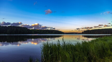 Sunset light in the sky over the lake in the East in summer