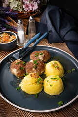 Meatballs with cheese served with boiled potatoes.