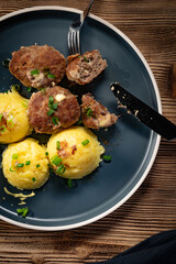 Meatballs with cheese served with boiled potatoes.