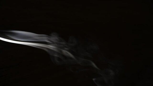 Smoke spiralling off an incense stick